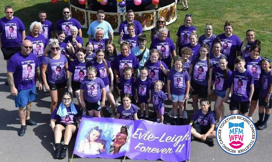 The Evie Leigh team — dozens of supporters in purple t-shirts holding the Evie-Leigh Forever 11 banner
